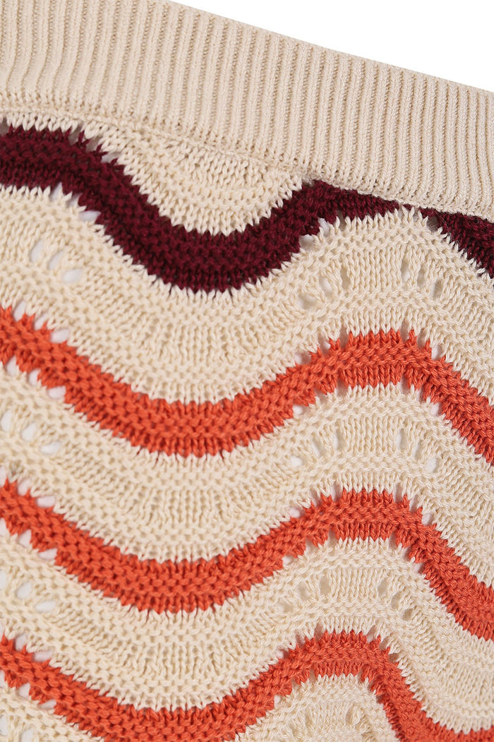 Cream knit shorts with orange and burgundy zigzag wave pattern and ribbed waistband