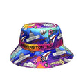 A colorful bucket hat featuring a vibrant Washington, DC themed print with illustrations of landmarks, stars, and the phrase 'CAPITOL' on a purple band, set against a plain white background.