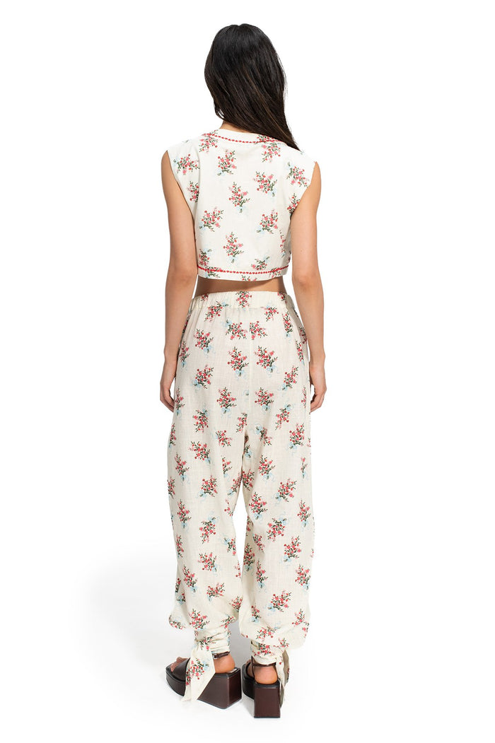 Silvia Pants in cream with scattered floral print, back view showing cropped sleeveless top and wide-leg pants with ankle ties