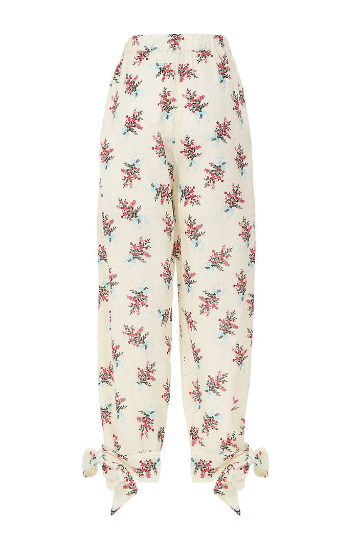 Silvia Pants in cream with repeated floral clusters in coral, pink, and turquoise with adjustable ankle ties