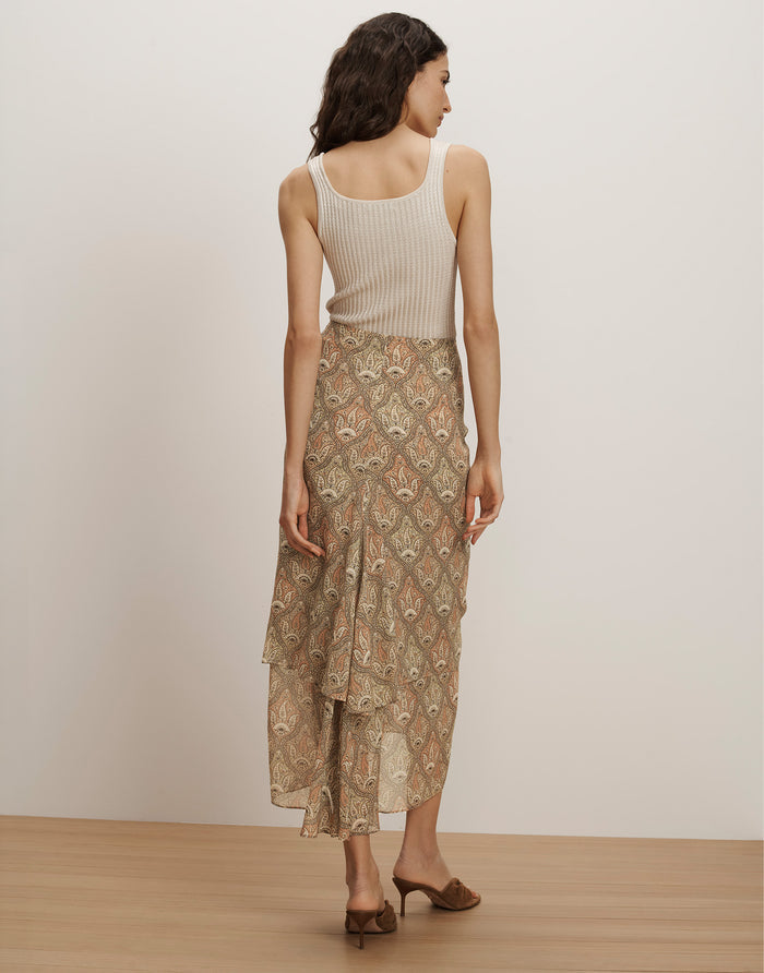 Veronica Beard Ribbed cream tank top and a flowing beige paisley print tiered midi skirt.
