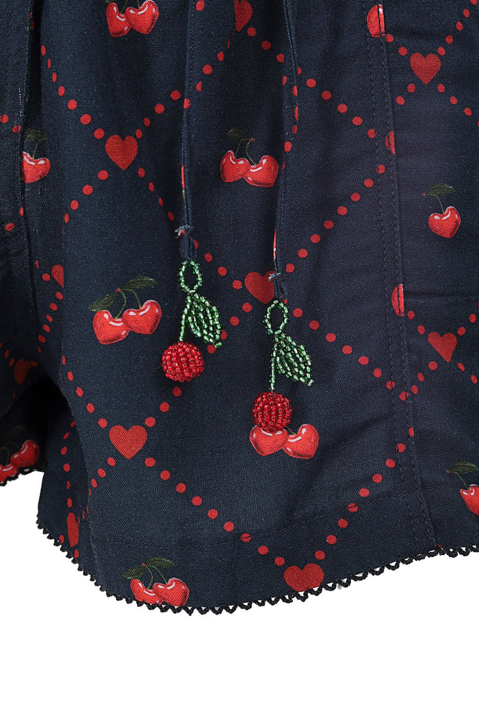 Navy shorts with embroidered red cherries, green leaves, and dotted hearts pattern with black crochet trim