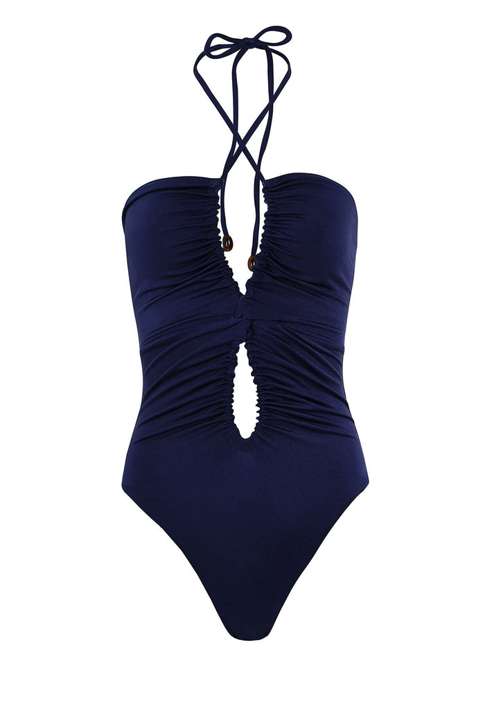 Navy blue one-piece swimsuit with ruched center cutout, halter tie straps, and shimmery finish