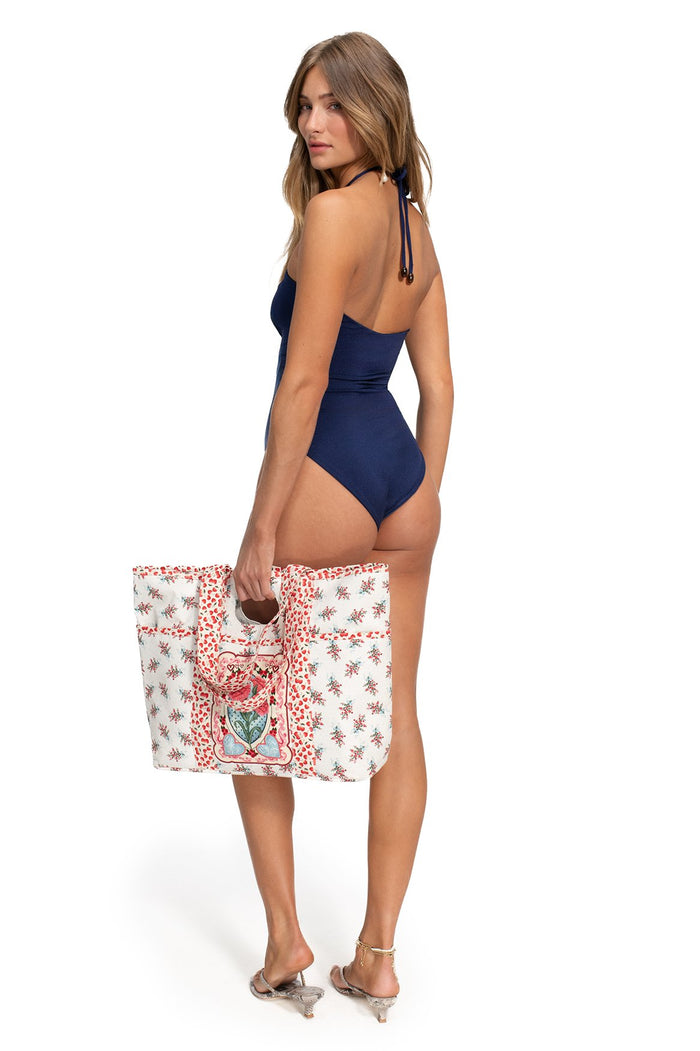 Navy blue Sory one-piece swimsuit with halter neck, cut-out details, and handmade tie ends, back view