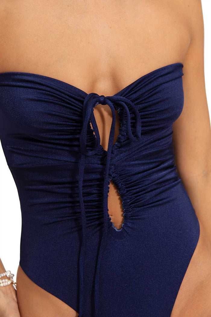 Navy blue one-piece swimsuit with ruched center cutout detail and tie closure at bust