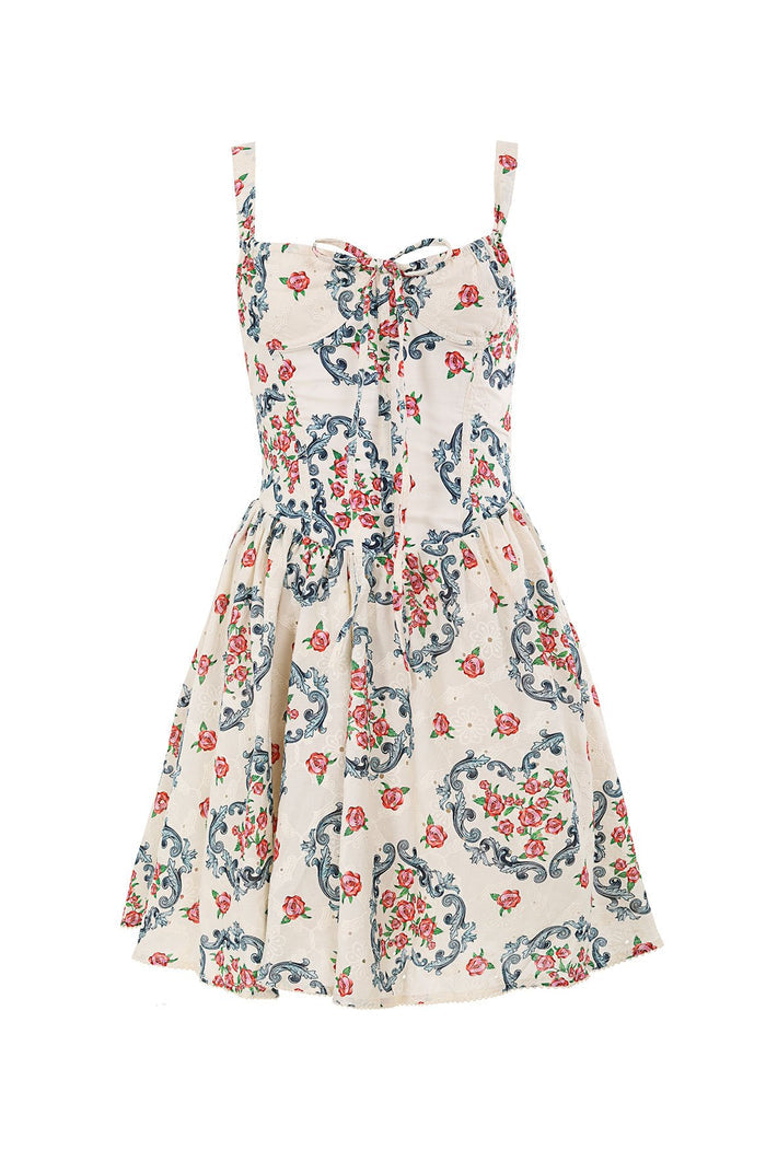 Cream mini dress with blue scrollwork and pink pattern detail print, structured bodice with underwire and eyelet fabric detail