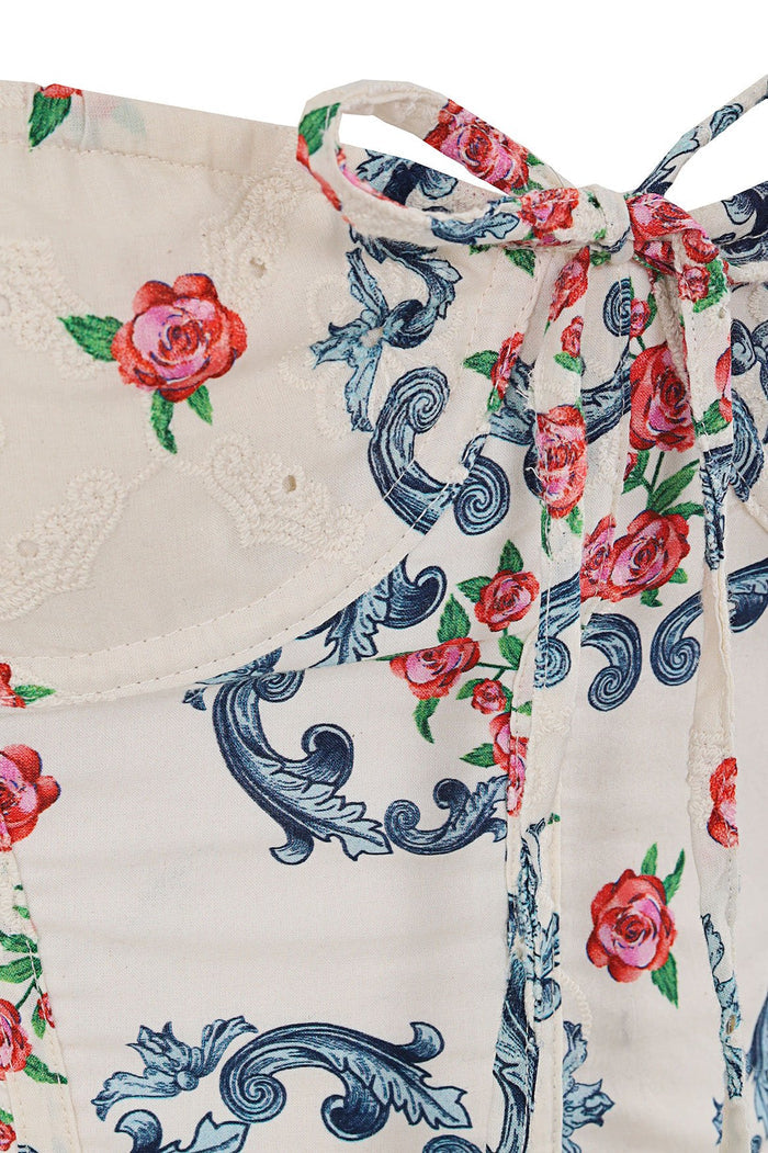 Spring mini dress in ivory with blue ornamental scrollwork and pink rose print, structured bodice with eyelet lace detail