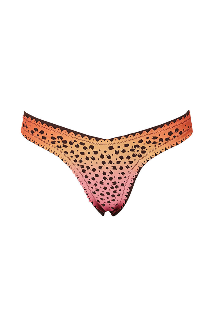 Tabita bikini bottom in ombre pink to orange gradient with laser-cut eyelet pattern and scalloped trim edges