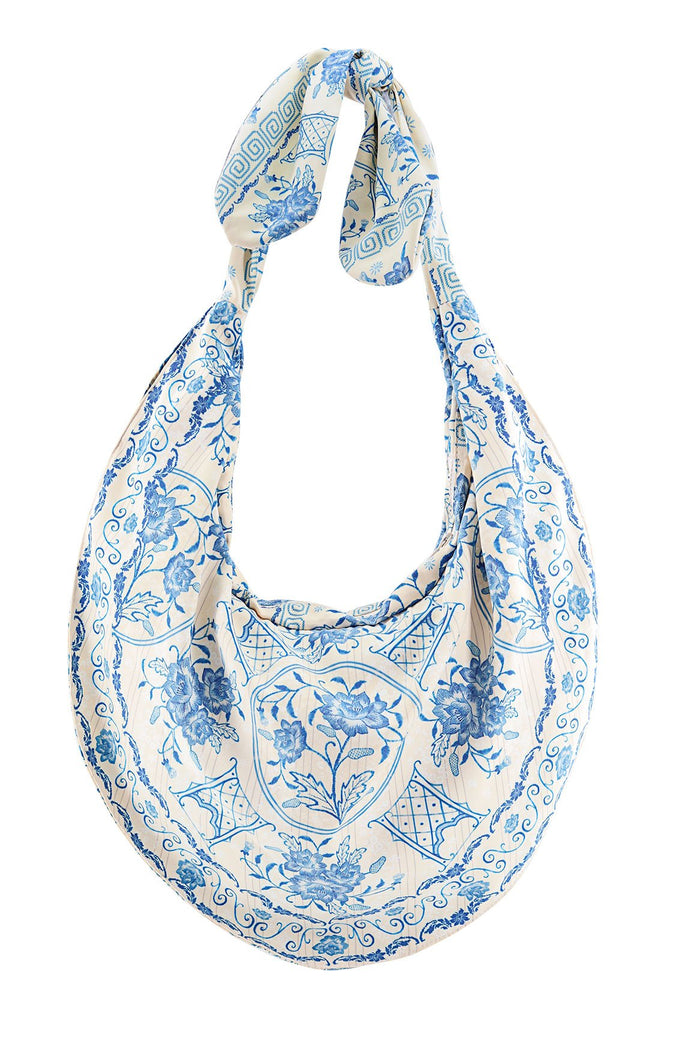 Tali Bag in cream with blue pattern detail print featuring scrollwork, geometric lattice borders, and knotted top handle