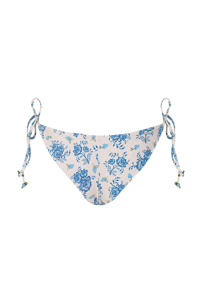 Tammy bikini bottom in white with blue pattern detail print and adjustable side ties with beaded details