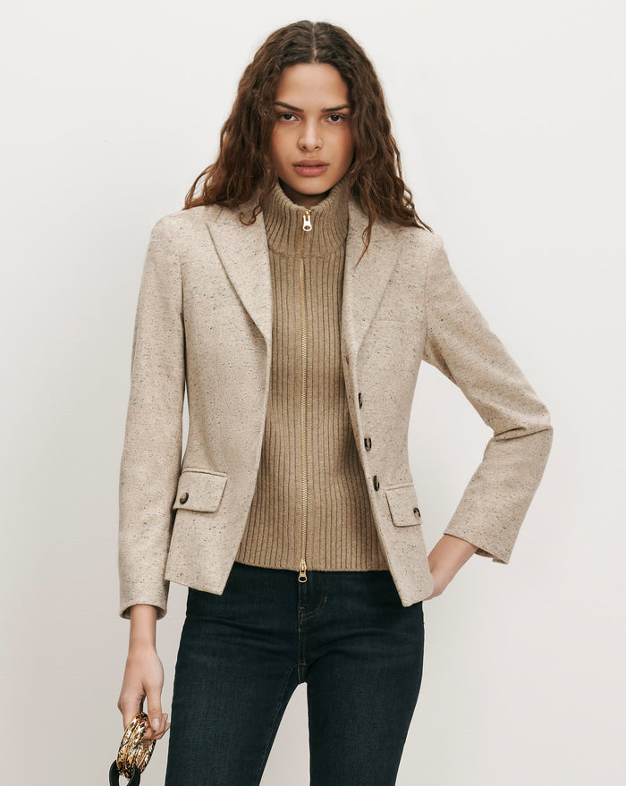 Veronica Beard Beige tweed blazer, ribbed turtleneck, and dark wash jeans.