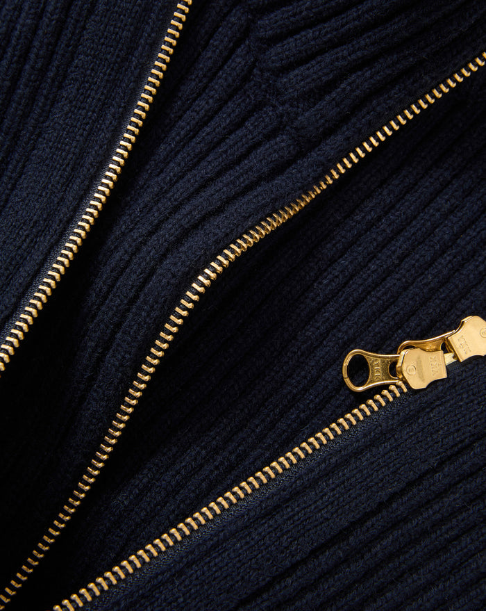 Veronica Beard Navy ribbed knit sweater with gold zipper.