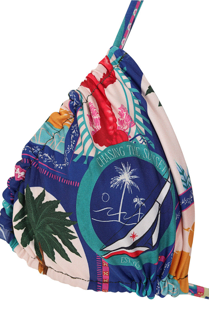 Triangle bikini top with vibrant multicolor print featuring palm leaves, embroidered florals, turquoise stripes, and white emblem details on navy and…