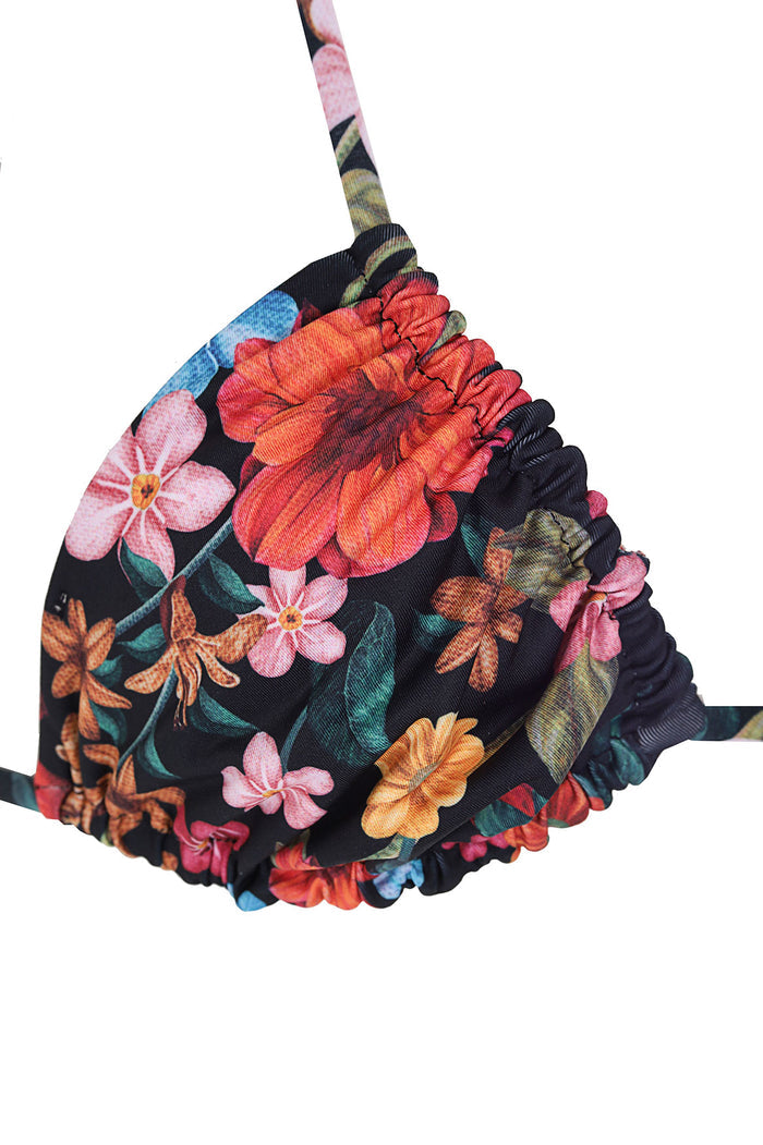 Triangle bikini top with black base and vibrant pattern detail print featuring pink, coral, orange, and blue blossoms with green leaves, ruffled edges