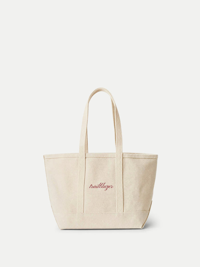 Veronica Beard Beige canvas tote bag with red script embroidery.