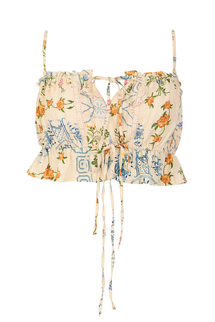 Vichy crop top in cream with blue tile print and orange pattern detail details, featuring ruffled hem, adjustable front lace tie, and removable straps