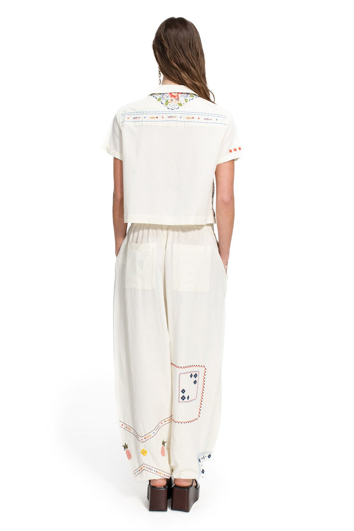 White cropped shirt with pattern detail embroidered collar and orange contrast stitching detail on shoulders and sleeve