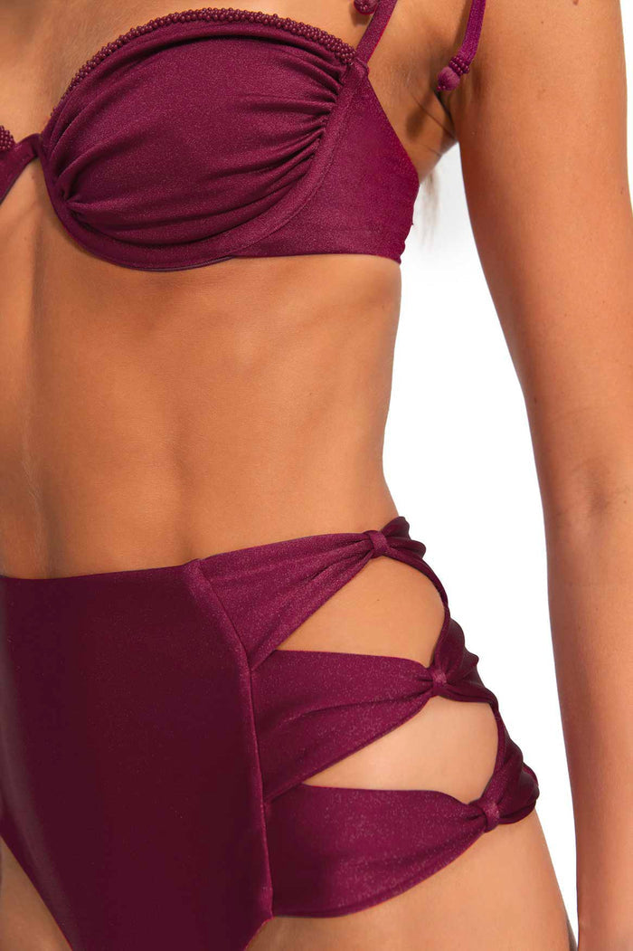 Burgundy high-waisted bikini bottom with cut-out side details and adjustable ties