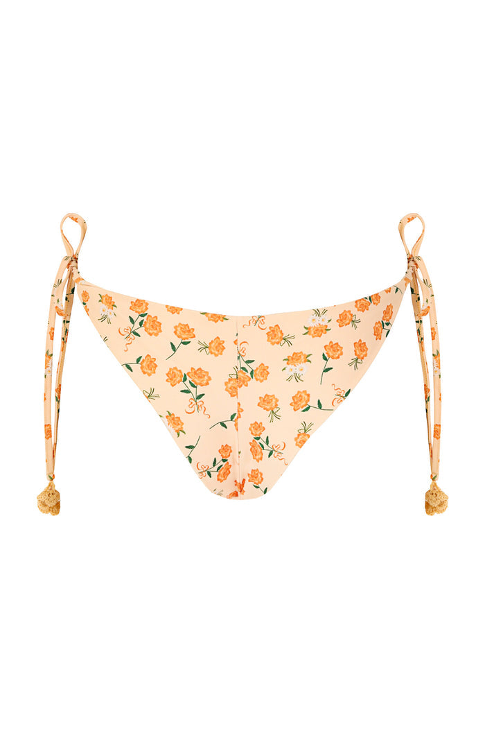 Yeimy bikini bottom in peach with orange pattern detail print, tie sides with crochet pompom details