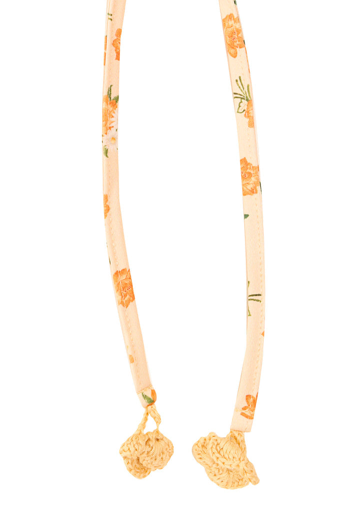 Yeimy bikini bottom straps in peach with orange pineapple print and handmade crochet pattern detail ties