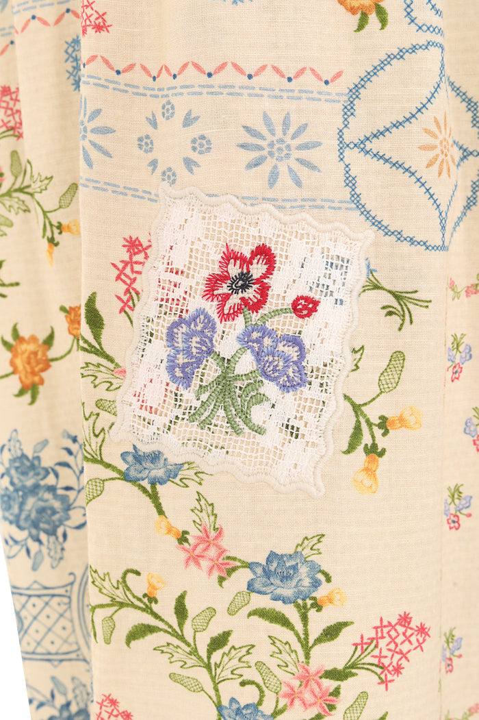Zadia pants in cream with embroidered botanical print and white lace appliqué detail at center front