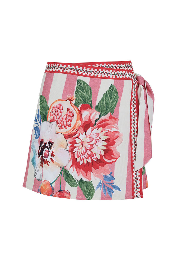 Ziara wrap skirt with pink and white vertical stripes, botanical pattern detail print featuring pomegranates and dahlias, and checkered trim at waist